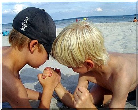 Boys do a showdown on the beach