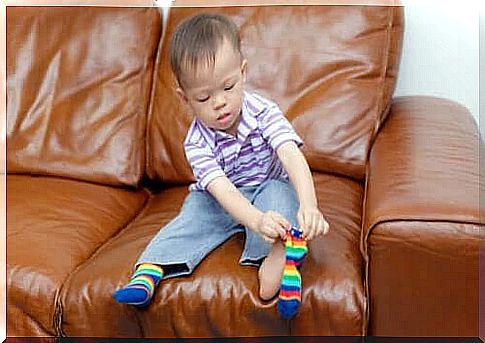 Toddler puts on his own socks
