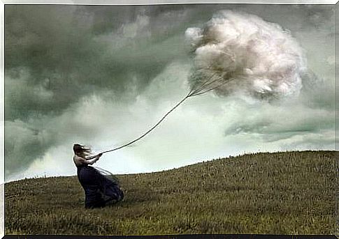 Woman flying a kite with a cloud