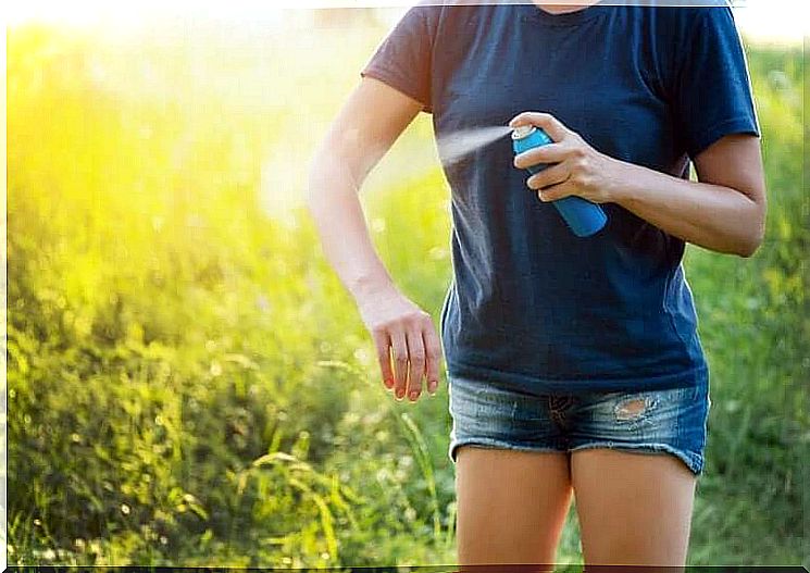 Woman sprays an insect repellent