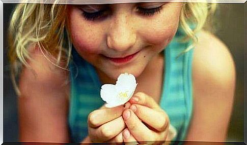 Girl With A White Flower In Her Hands That She Wants To Put In The Lucky Jar