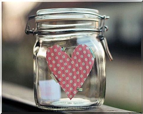 A Glass Jar With A Heart On It Used As A Family's Happiness Jar